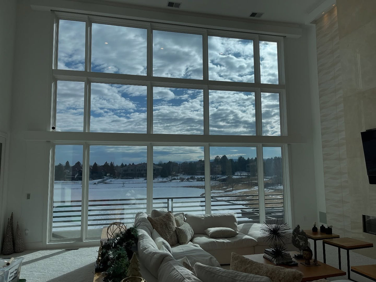 Living room with large windows window tint no shades glare and heat reduction