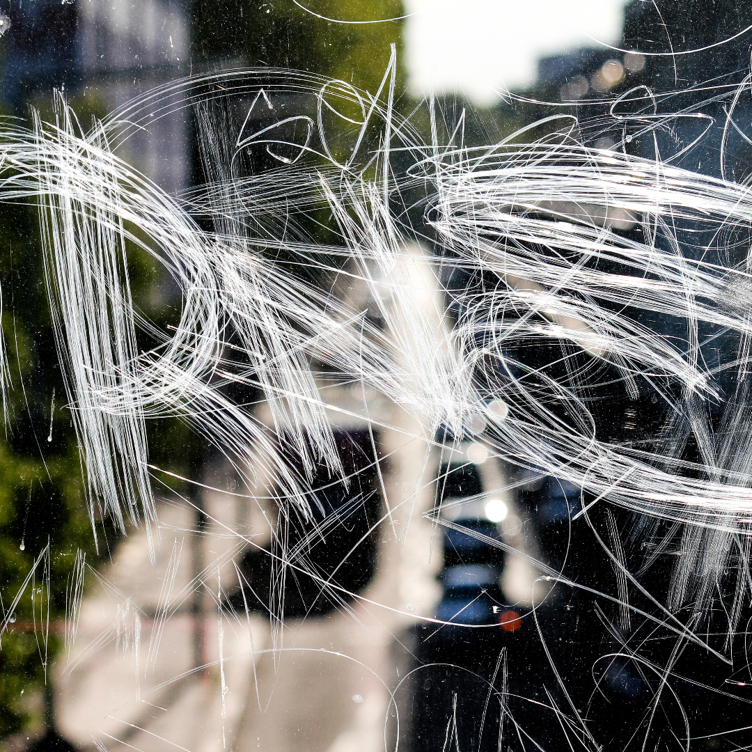 Scratched glass surface with white streaks, Security Window Tint Protection